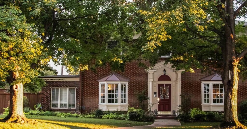 An image of trees in front of a home.